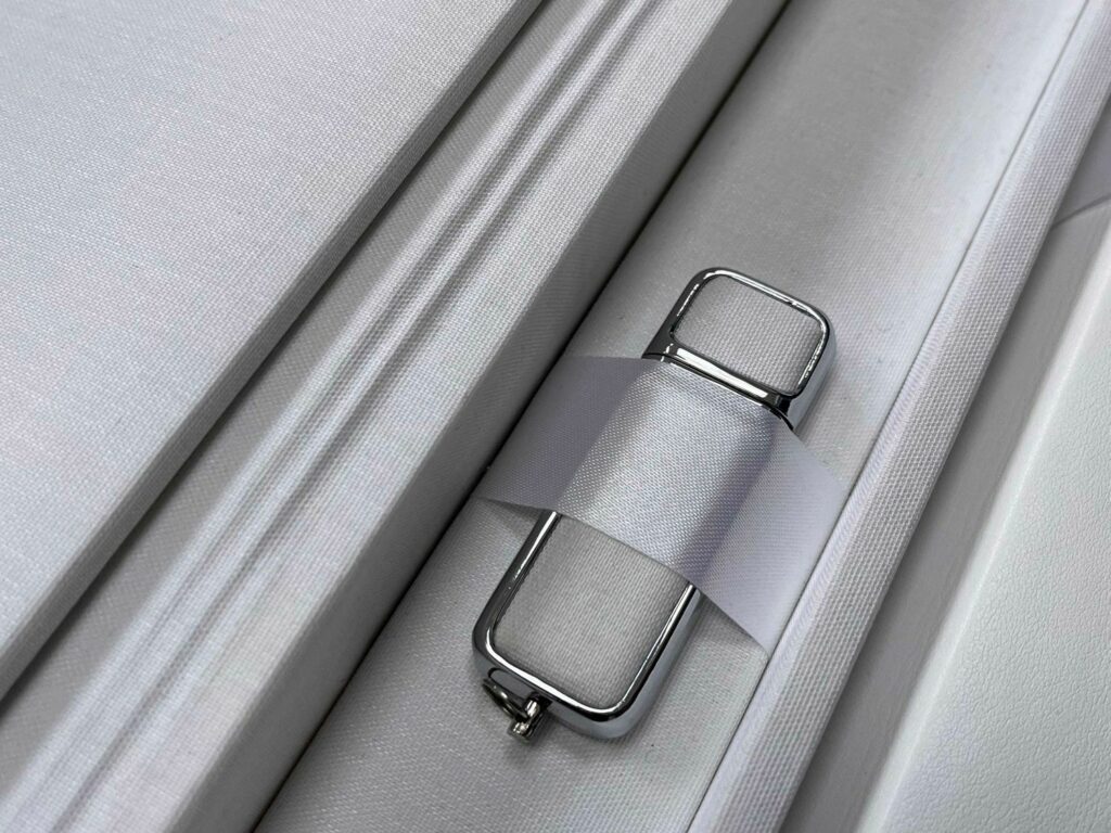 A close up of a silver suitcase with a lock.