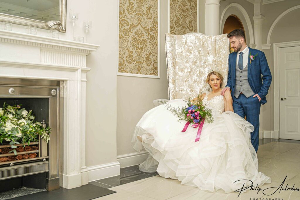 Bride and groom in elegant wedding attire indoors.