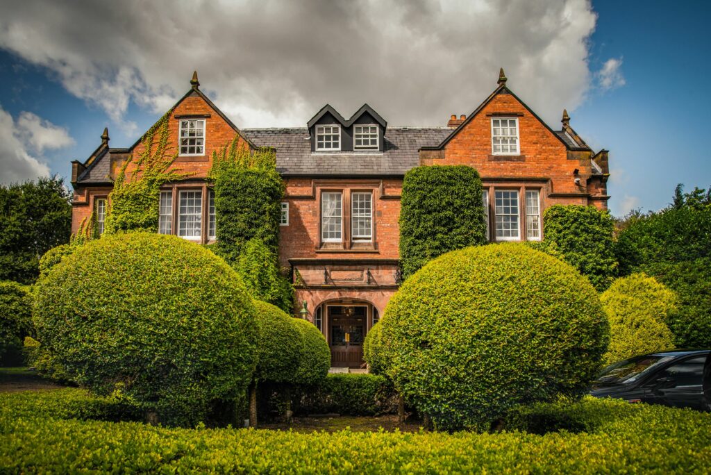 Traditional British brick house with manicured garden.