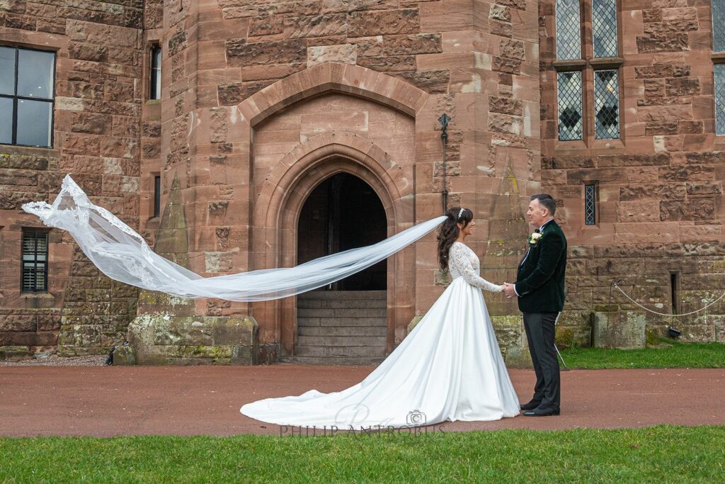 Bride and groom outside historic building.
