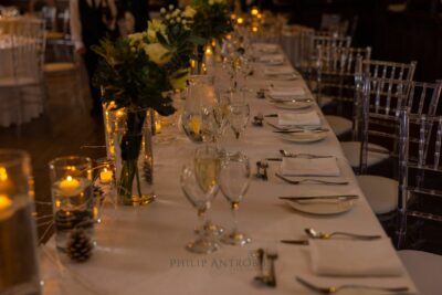 Elegant wedding table setting with candles and flowers.