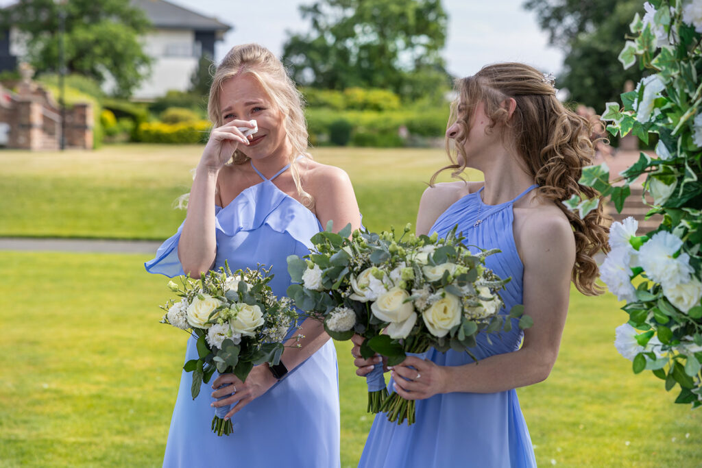Bridesmaids crying at outdoor wedding at Carden Park Chester