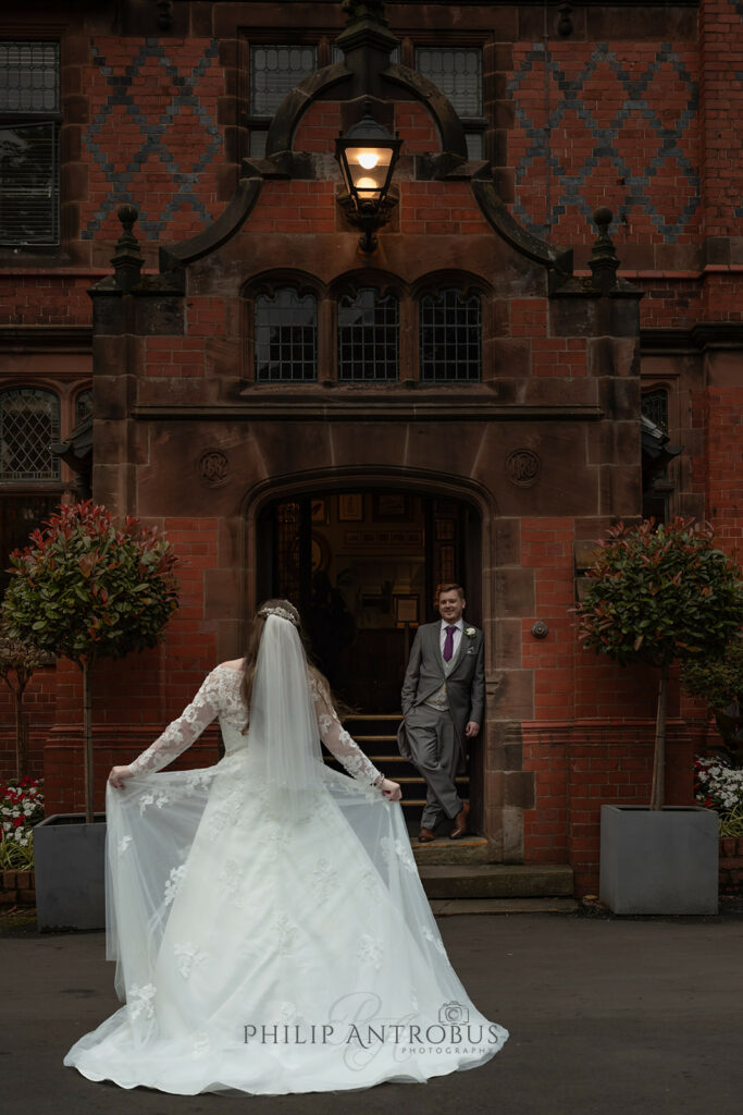 Bride approaching groom at wedding at Chester Zoo wedding