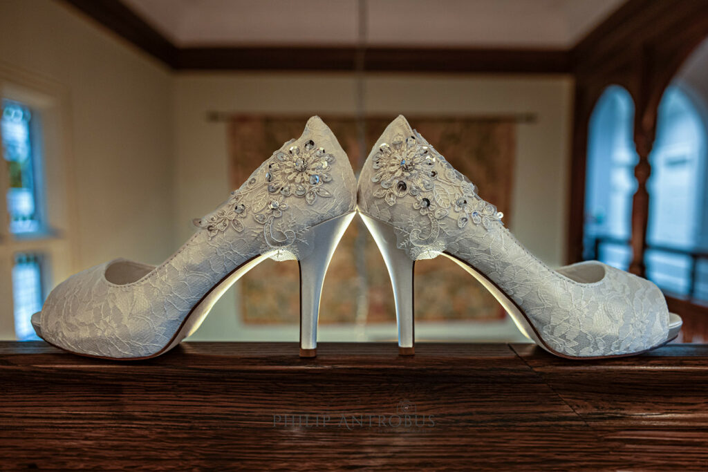 Elegant bridal lace heels on wooden surface at Chester Zoo wedding venue