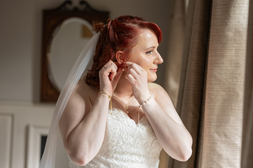 Bride adjusting earings north wales wedding