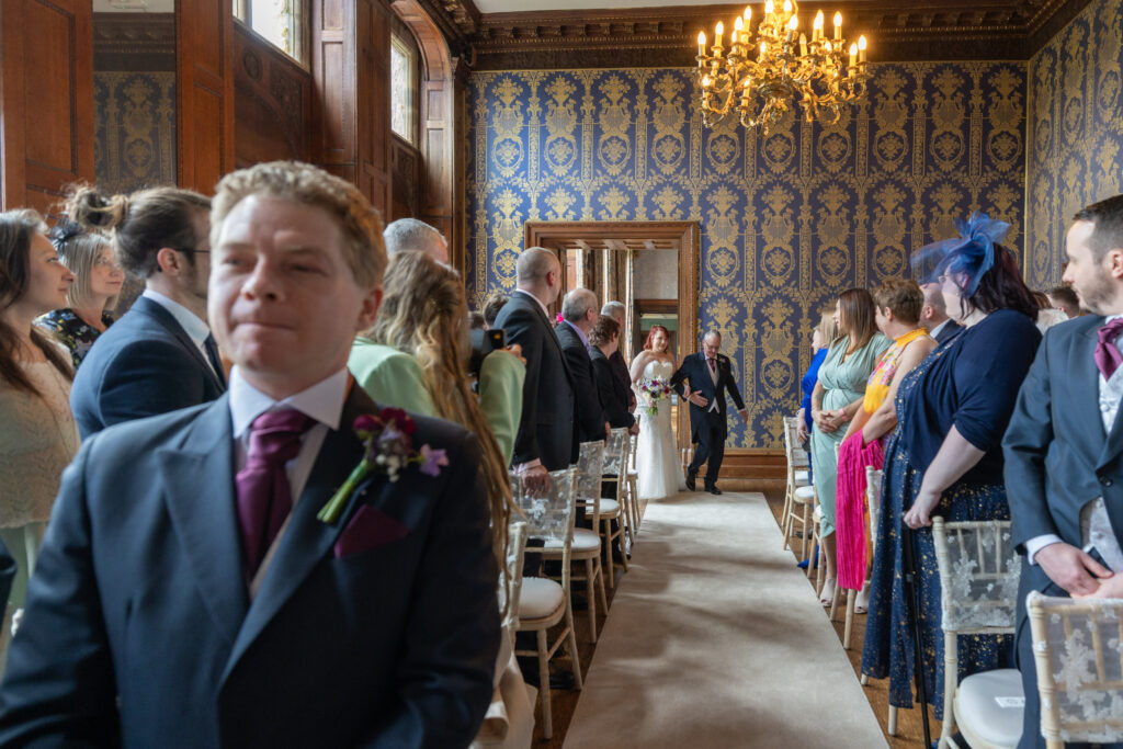 Bride entering room at Soughton Hall.