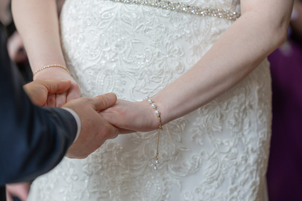 Bride and groom holding hands at North Wales wedding venue