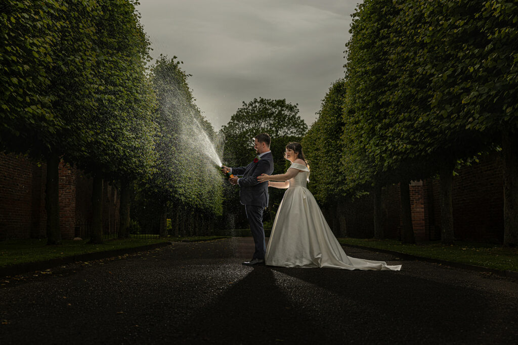 Bride and groom celebrating with champagne.