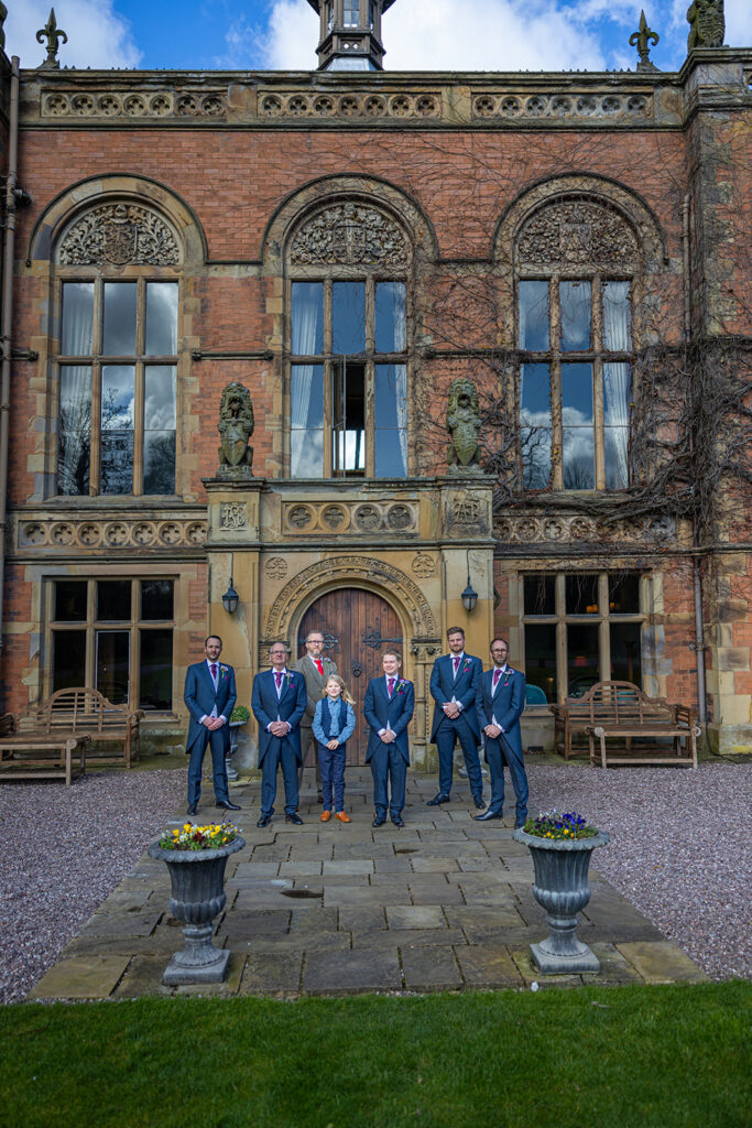 Group photo in front of historic building entrance.