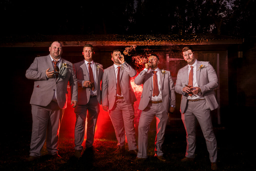 Groomsmen smoking cigars. Wedding photography Cheshire
