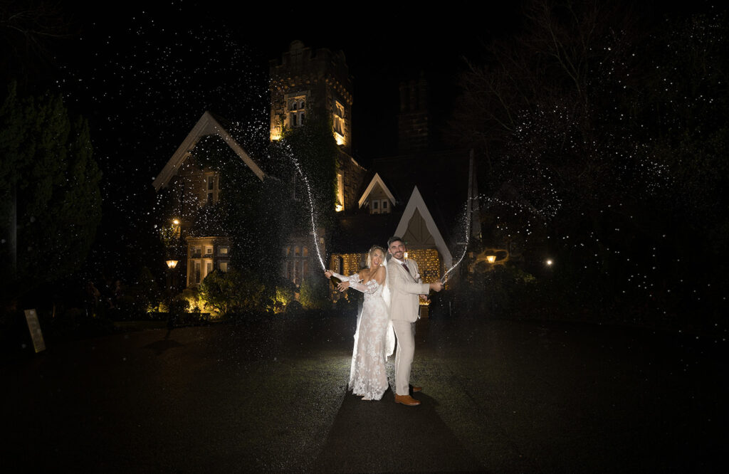 Champange spray with bride and groom at West Tower Wedding Photography by Philip Antrobus