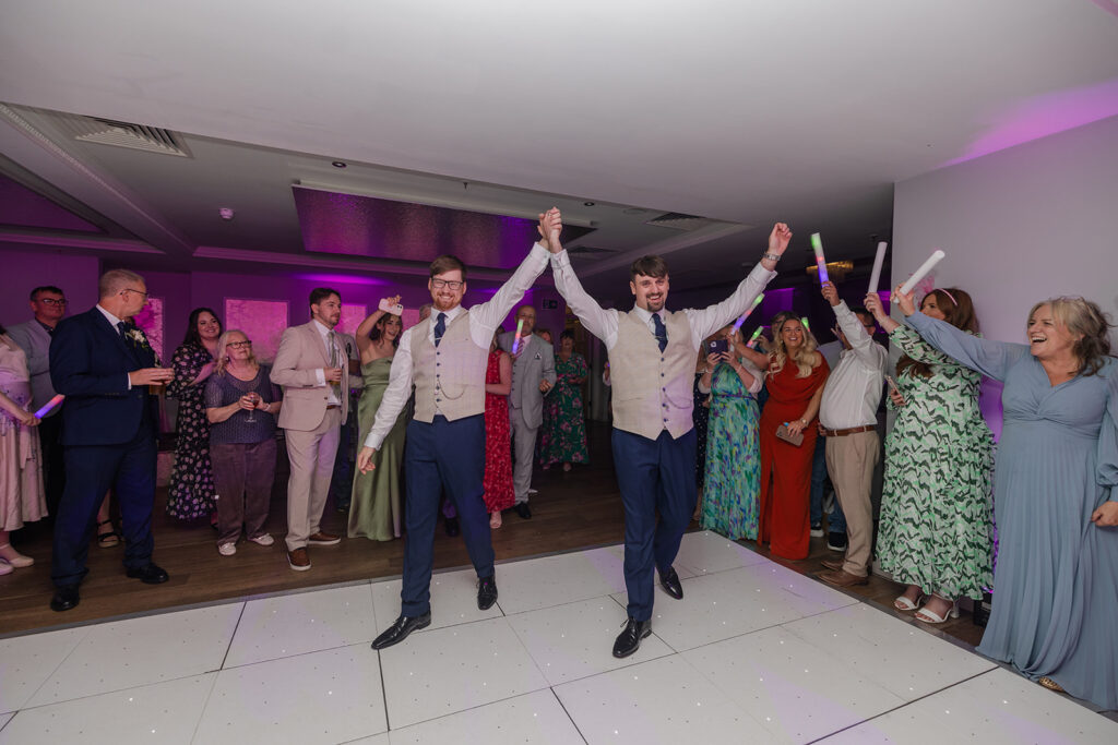 Happy couple celebrating with guests at wedding reception at the old palace chester