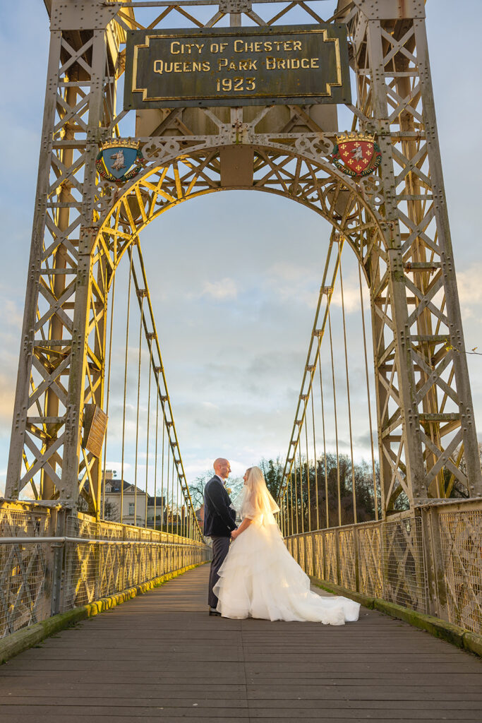 Couple on Queen's Park Bridge, Chester, wedding scene.