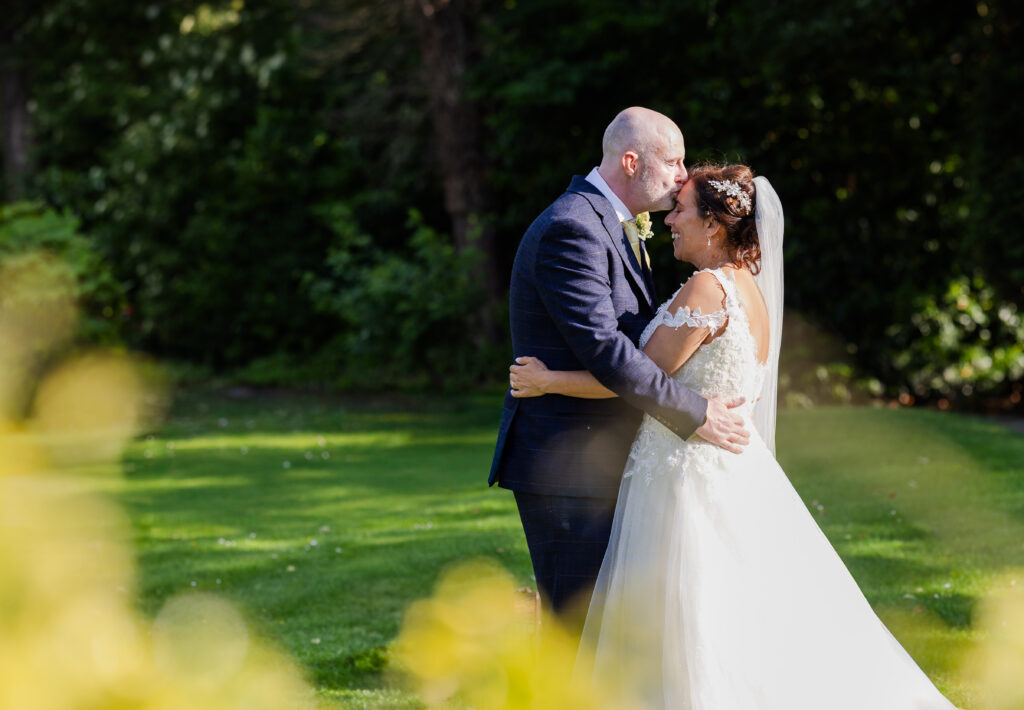 A bride and groom stand outdoors at North Wales Wedding Venue.