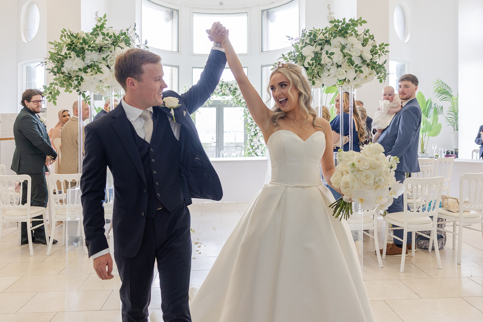 Happy wedding couple celebrating with guests.